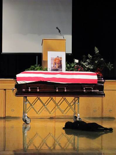 Dog mourns at casket of fallen Navy Seal